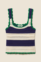 Crocheted tank top with blue and green stripes on a beige background