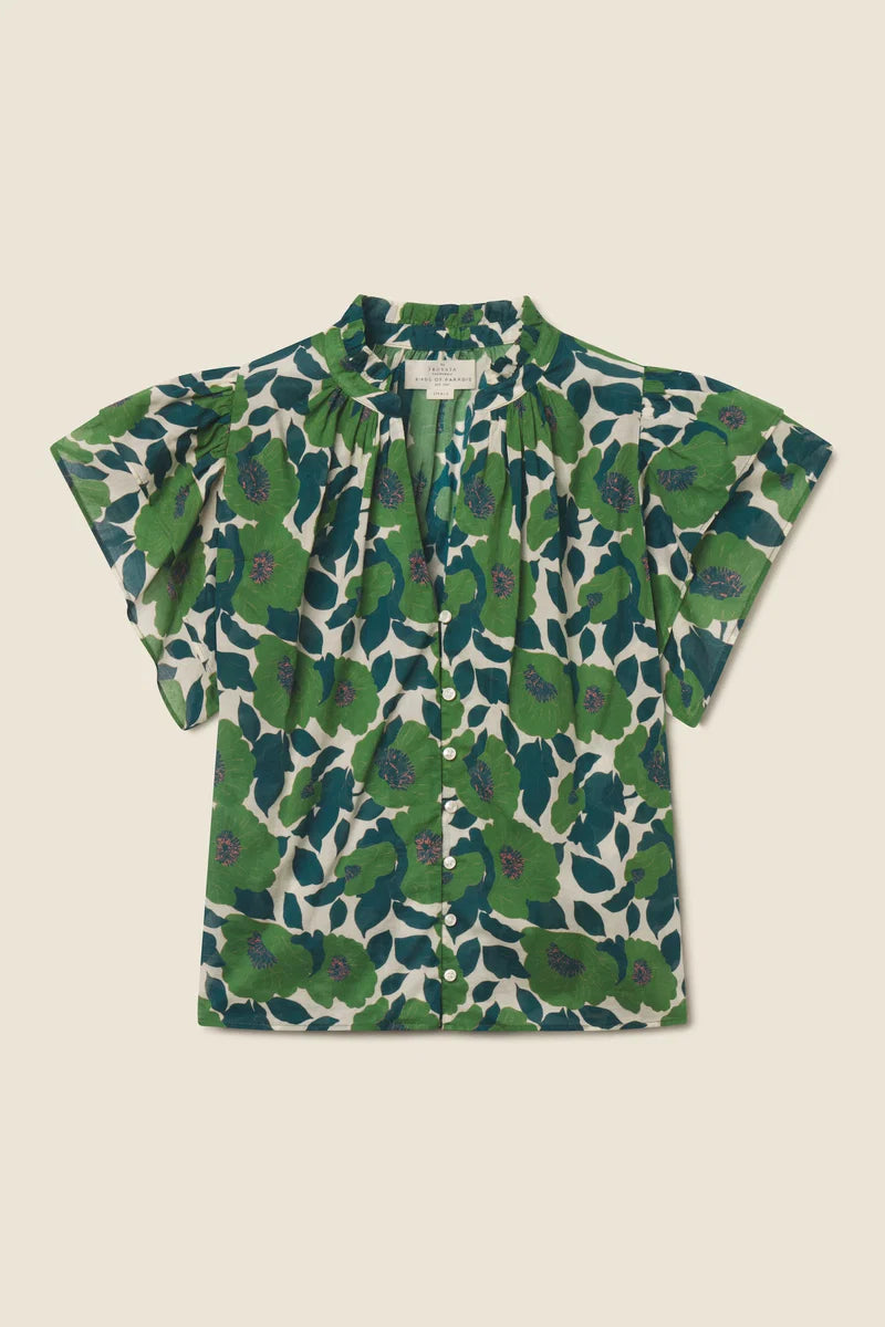 Green floral patterned blouse on a beige background