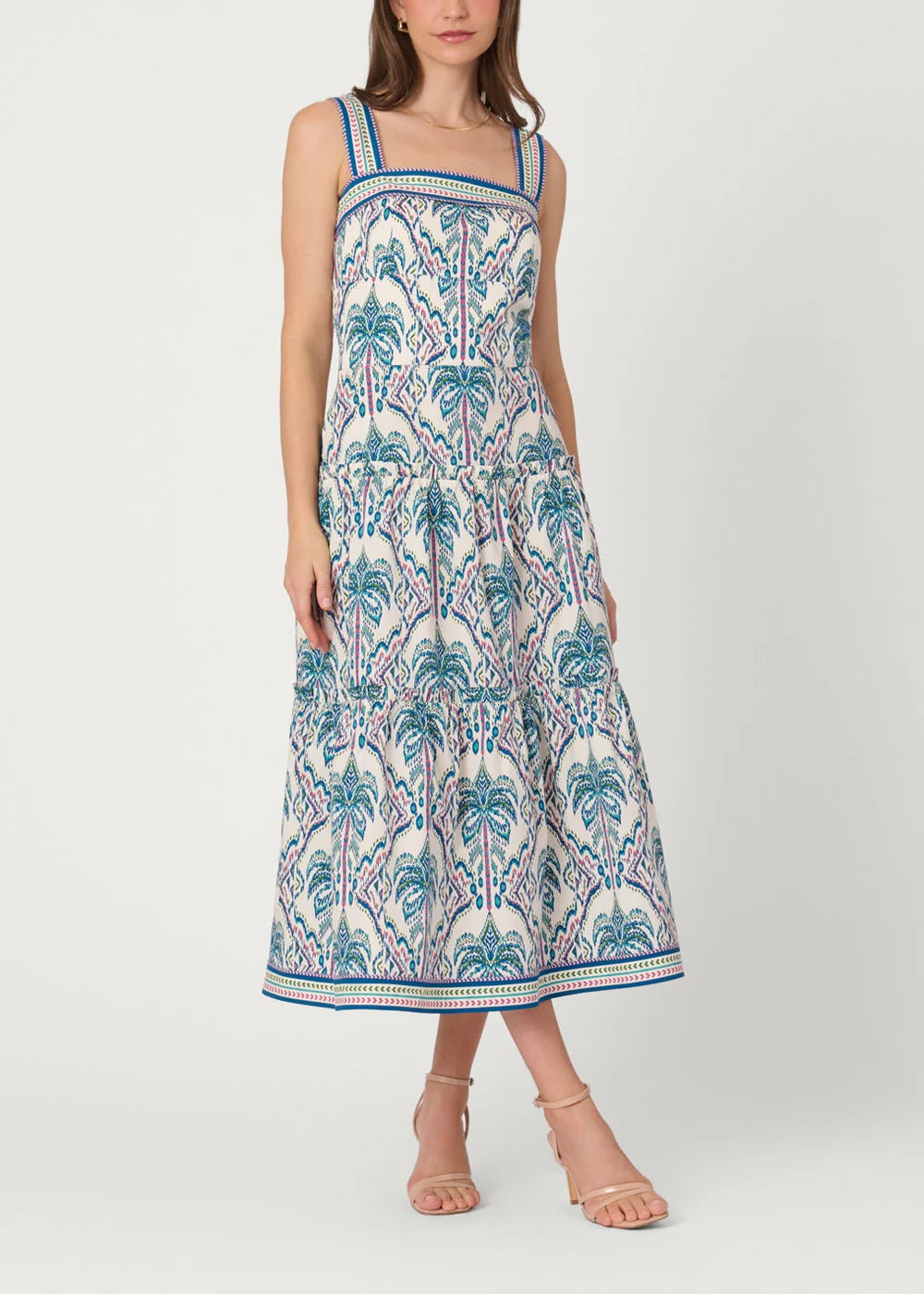 Woman wearing a patterned dress on a white background