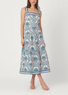 Woman wearing a patterned dress on a white background