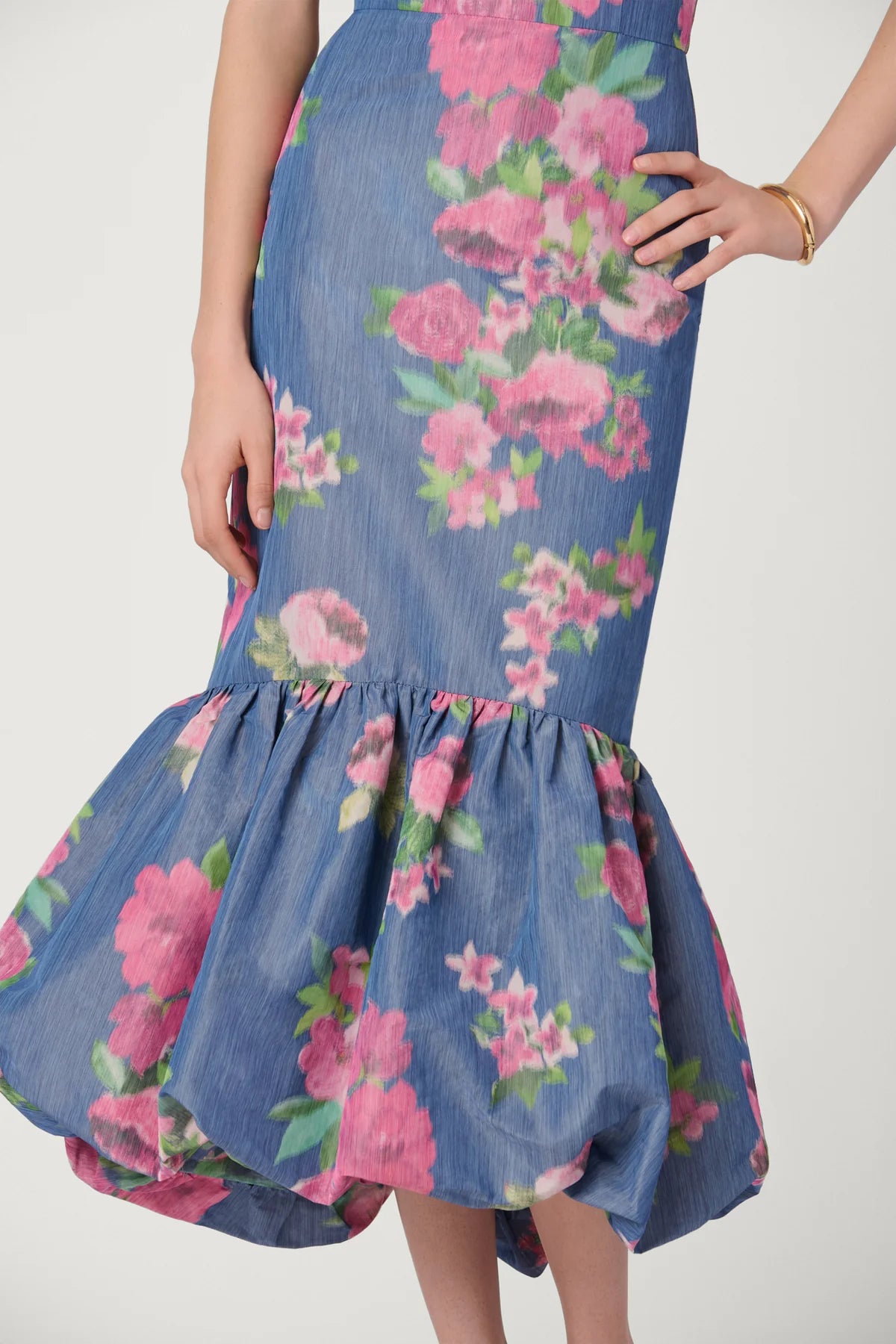 Blue floral dress with pink flowers on a plain background