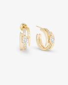 Gold hoop earrings with diamond accents on a white background
