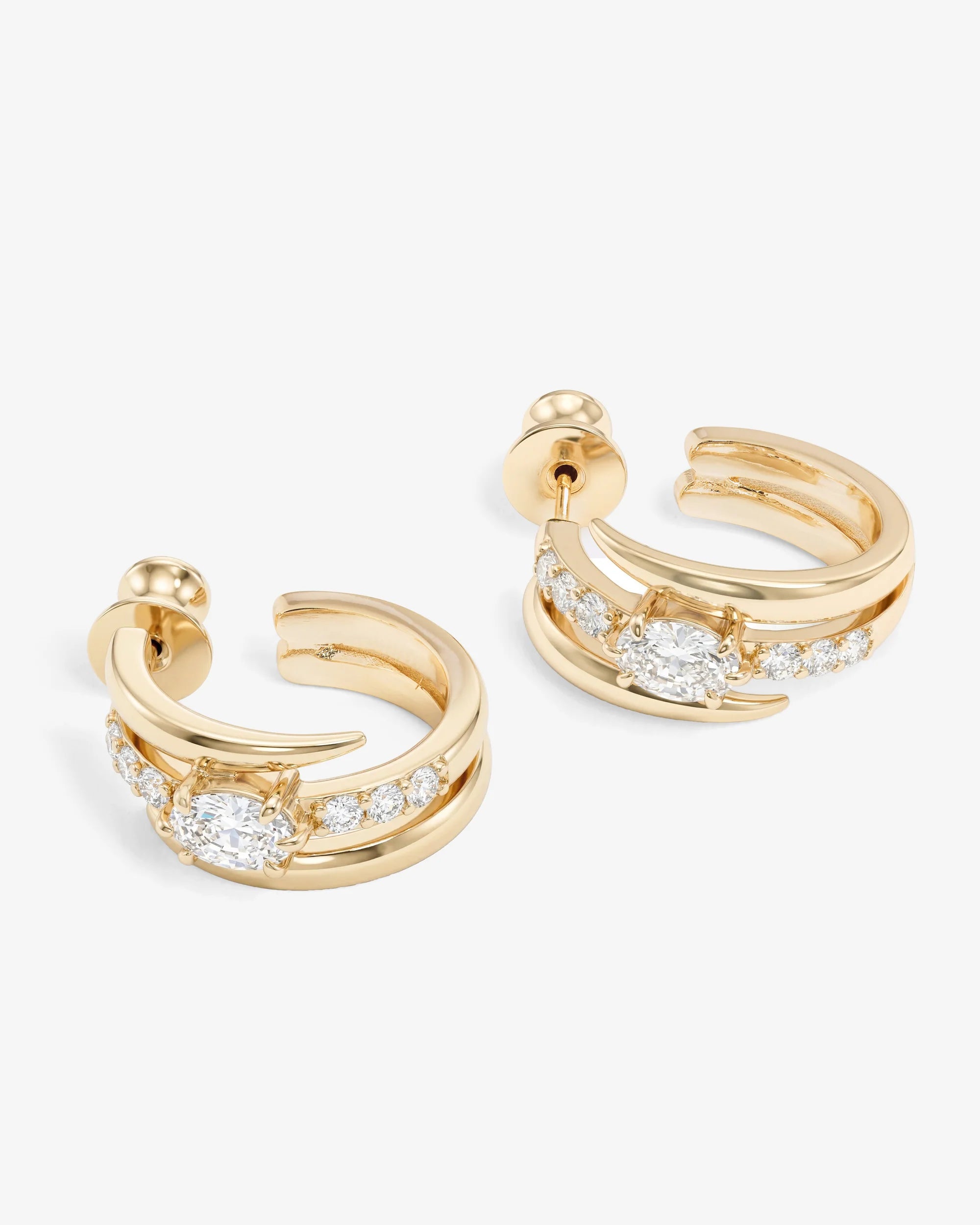 Gold hoop earrings with diamond accents on a white background