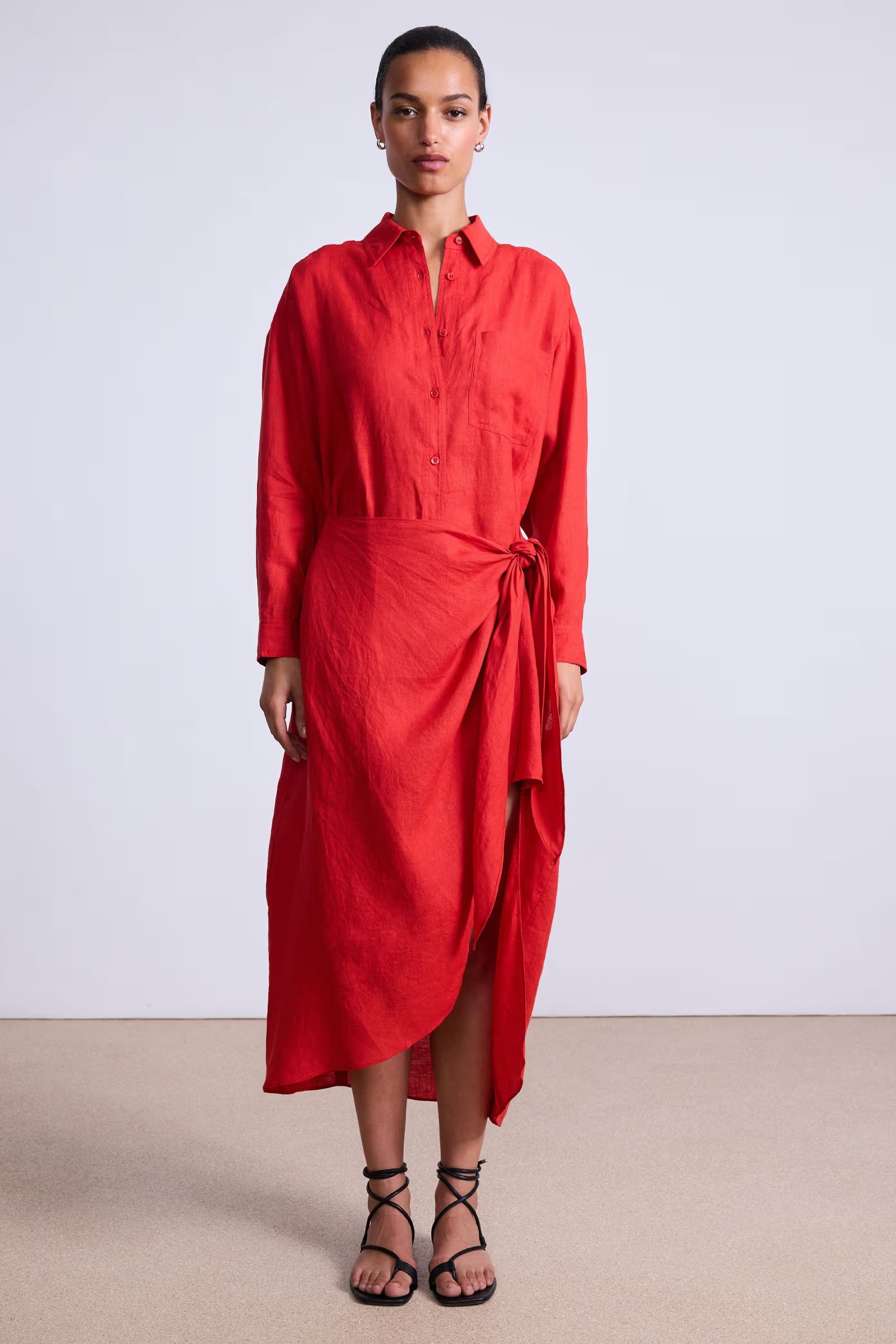 Woman wearing a red dress with a white background
