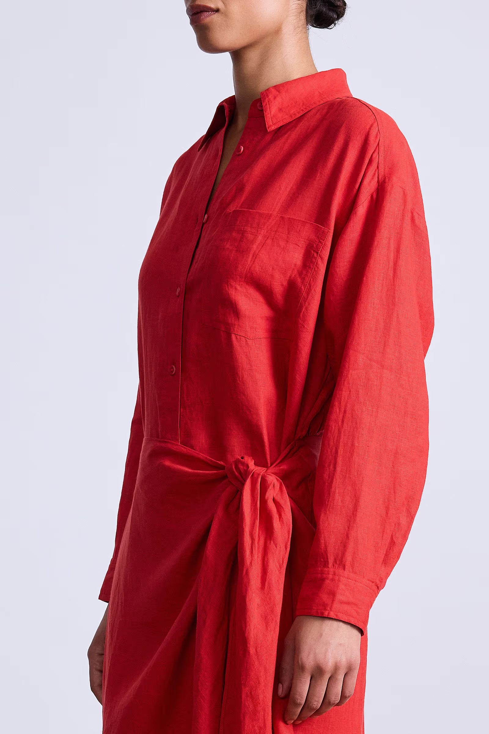 Red shirt dress worn by a person on a light gray background