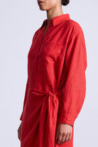 Red shirt dress worn by a person on a light gray background