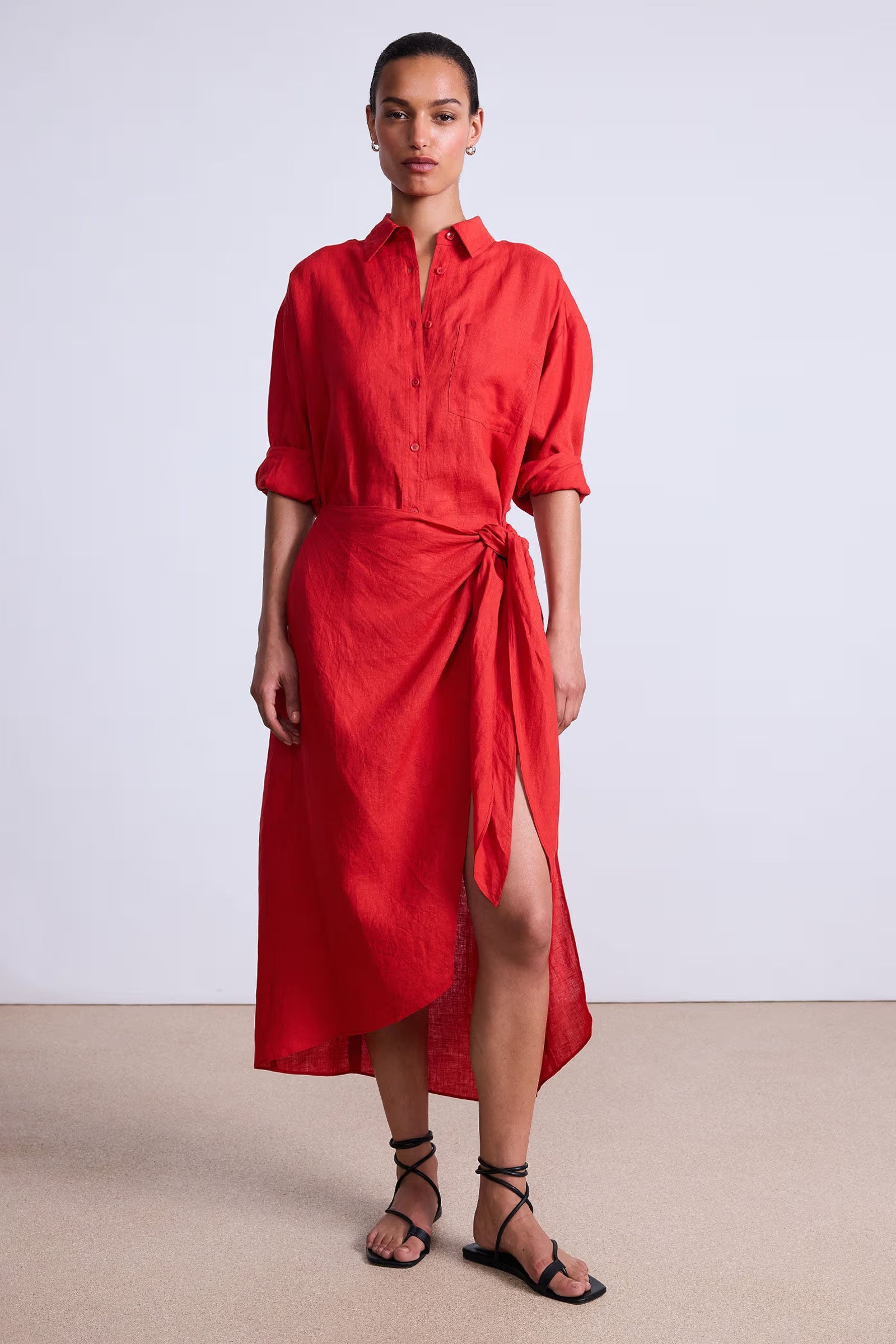 Woman wearing a red dress with a white background