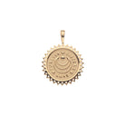Gold pendant with engraved text on a white background