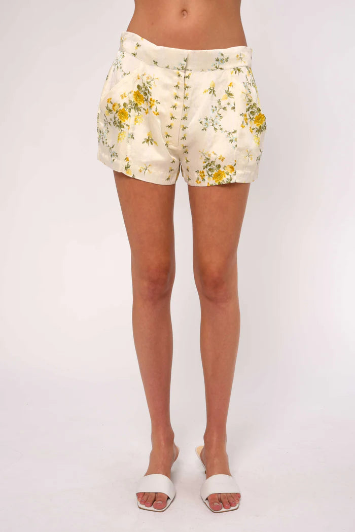 Floral shorts worn by a person on a white background
