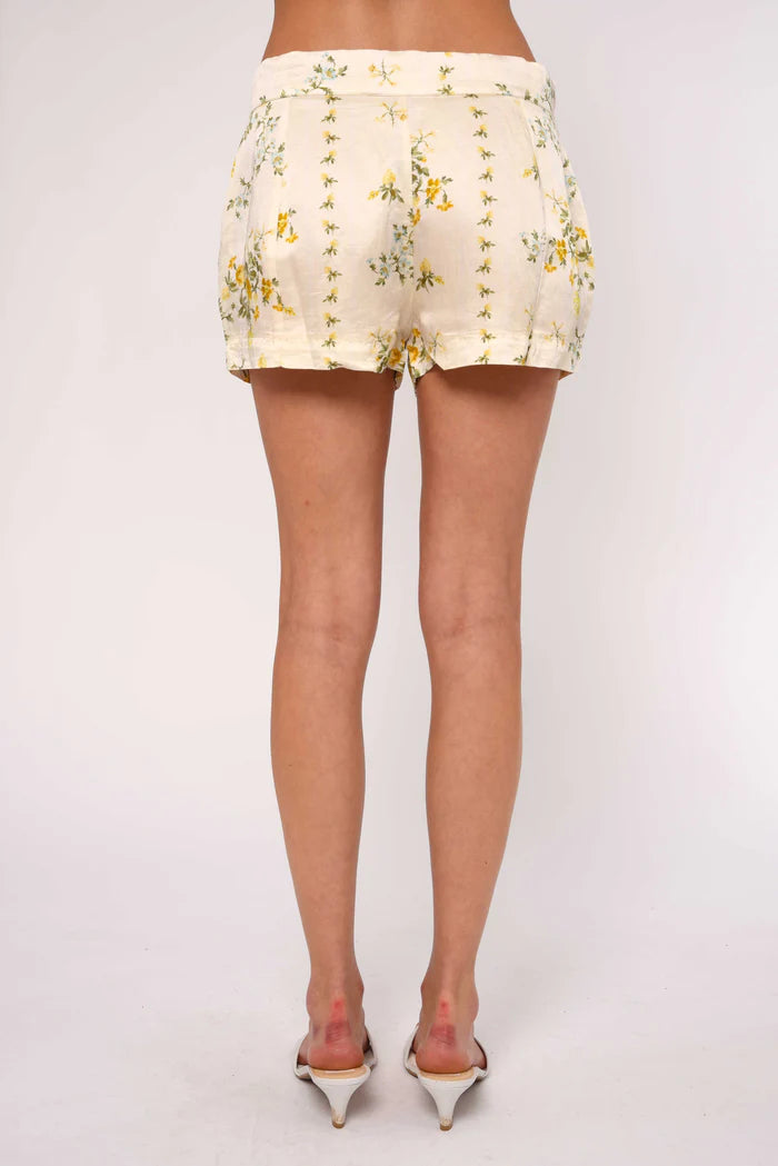 Floral shorts worn by a person on a plain background
