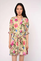 Woman wearing a floral dress against a white background