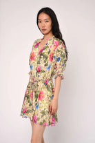 Woman wearing a floral dress against a white background