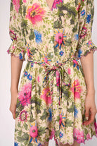 Floral dress with colorful pattern on a plain background
