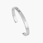 Silver bracelet with small diamonds on a white background