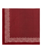 A square red scarf with a dense white micro-dot pattern and ornate borders, displayed flat against a white background.