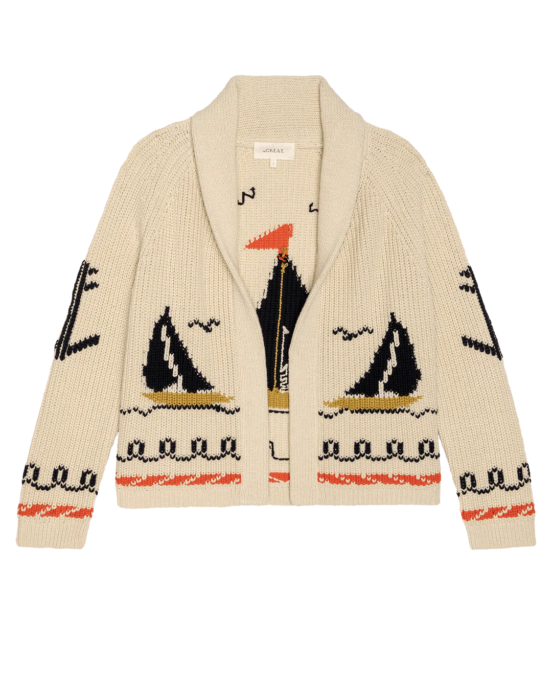 Beige cardigan with sailboat pattern on a white background