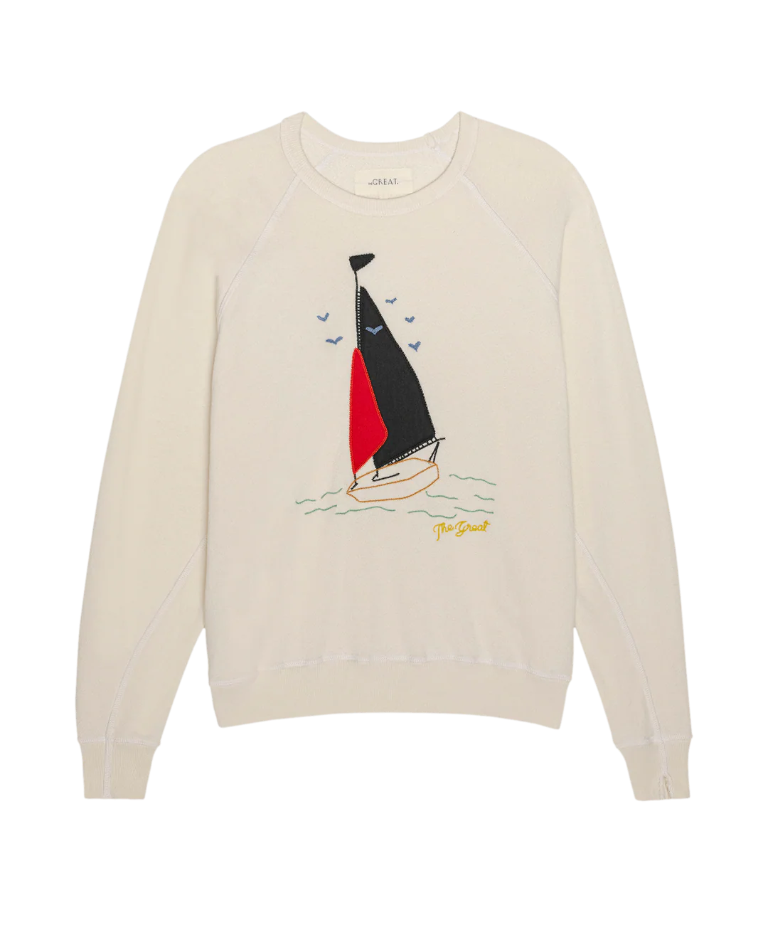 Beige sweater with sailboat design on a white background