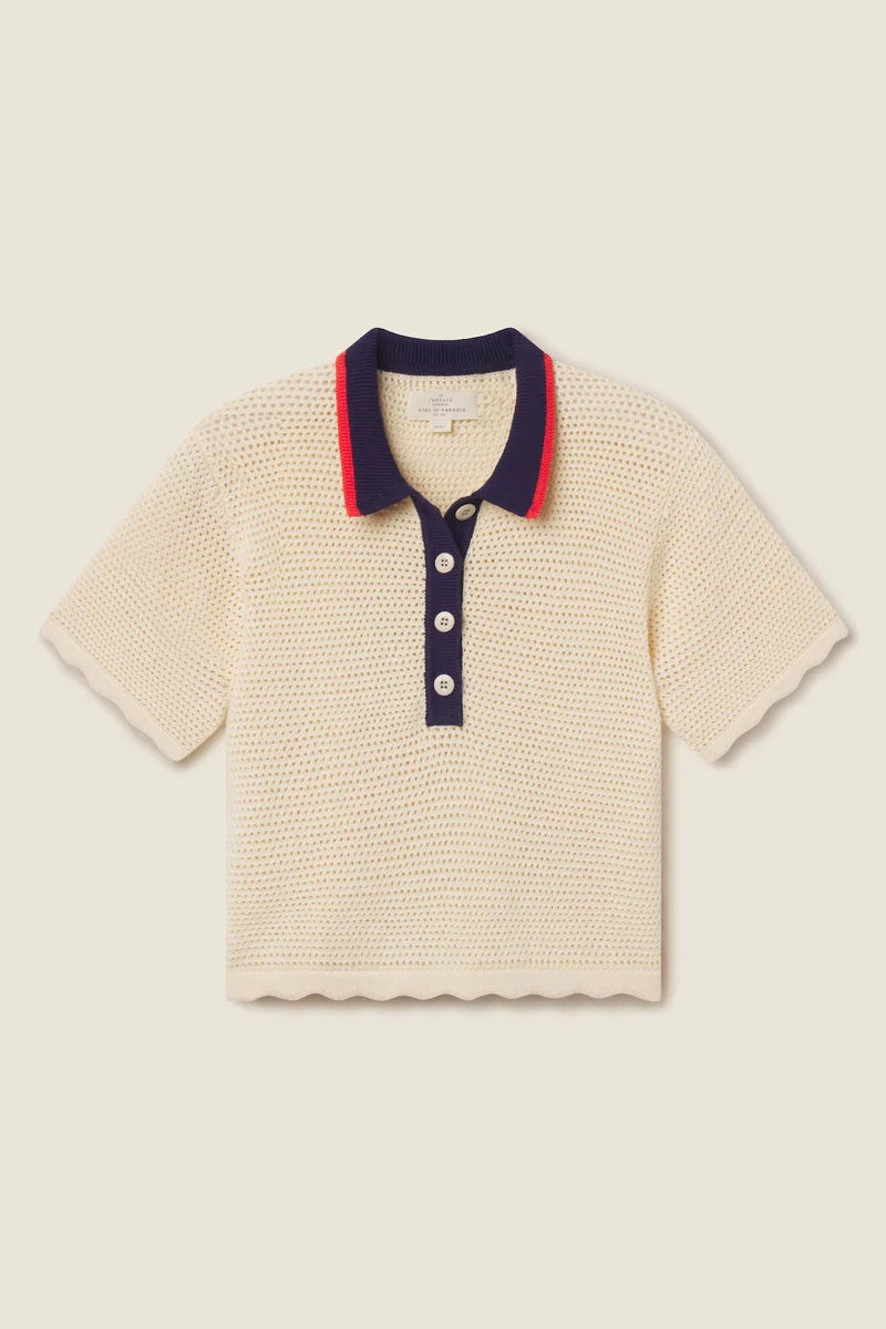 Beige textured polo shirt with navy collar and buttons on a beige background