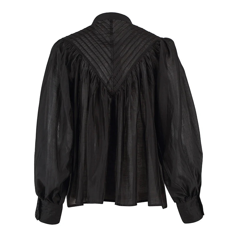 Black blouse with puffed sleeves on a white background