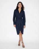 Woman wearing a navy blue dress on a white background