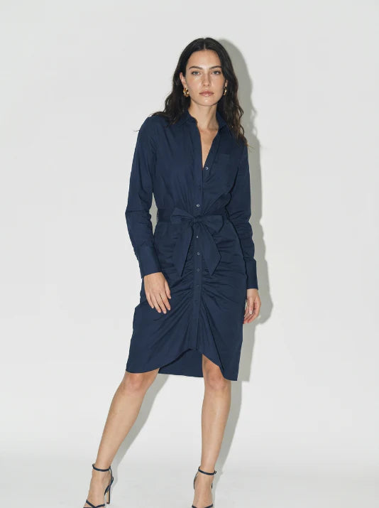 Woman wearing a navy blue dress against a white background