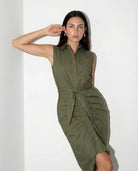 Woman wearing a green dress against a white background