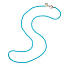 Turquoise beaded necklace with a gold clasp on a white background