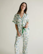 women wearing pajamas with a green waist tie and a white background