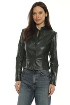 A woman modeling a black faux-leather cropped jacket with a high stand collar and front zipper, paired with blue jeans, against a plain white background.