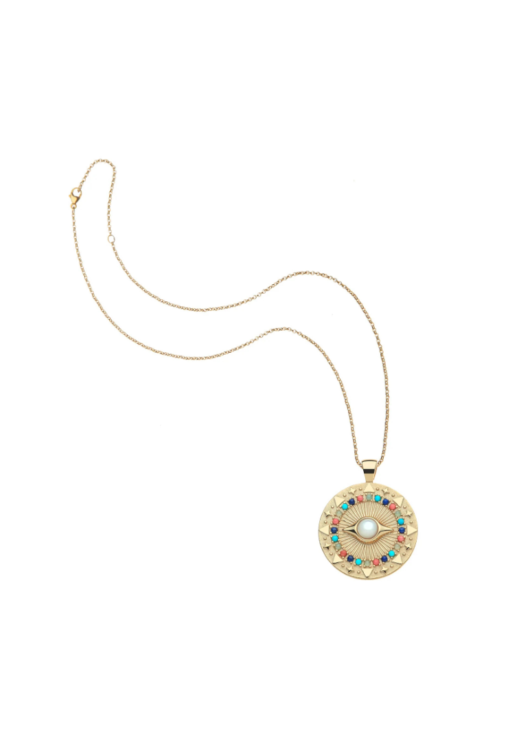 A gold chain necklace with a circular pendant featuring a central white pearl and a surrounding halo of small turquoise, red, and green stones on a plain white background.