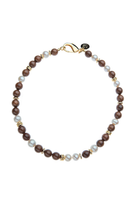 A beaded necklace featuring dark brown wooden beads, white faux pearls, and small gold spacer beads, completed with a gold clasp on a solid white background.