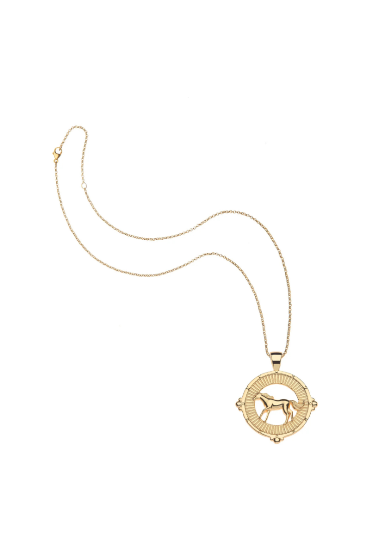 A gold necklace featuring a circular pendant with a horse silhouette in the center, displayed on a clean white background.