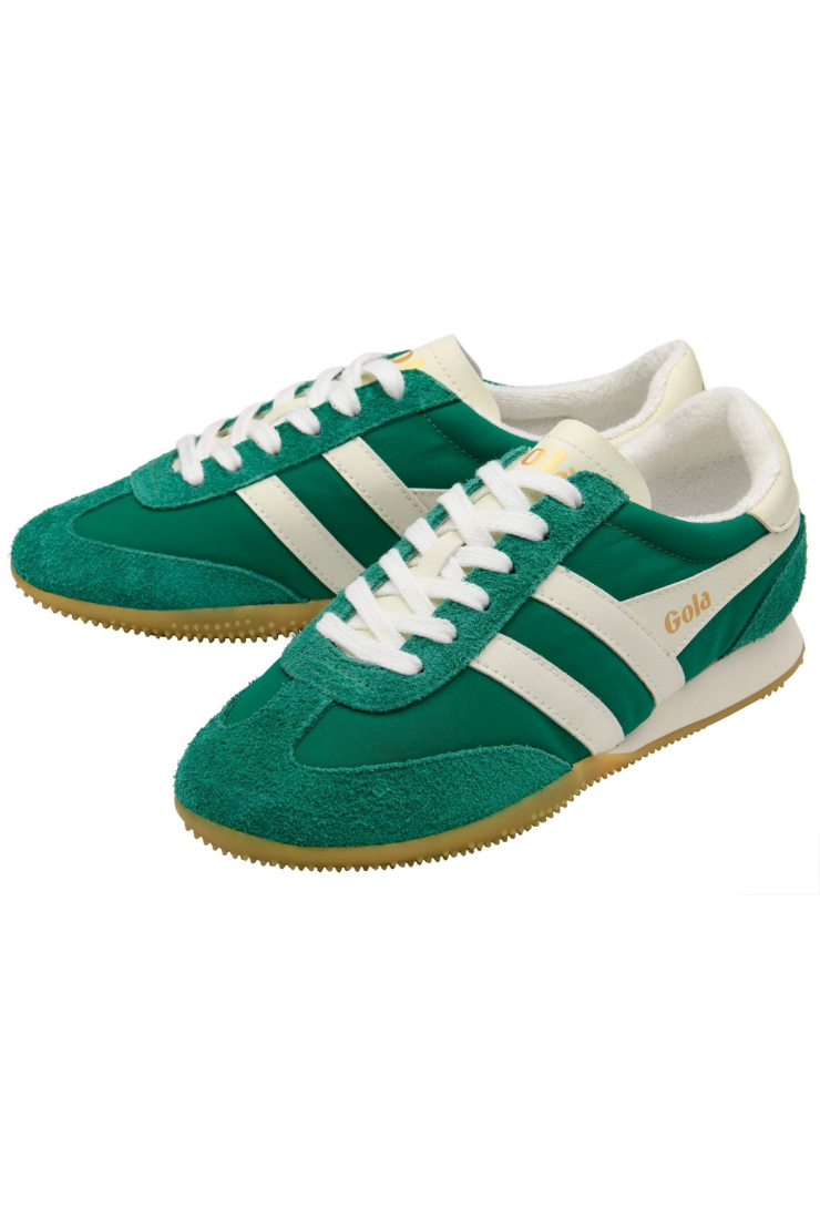 A pair of green suede sneakers with white side stripes, white laces, and a gum sole, shown on a plain white background.