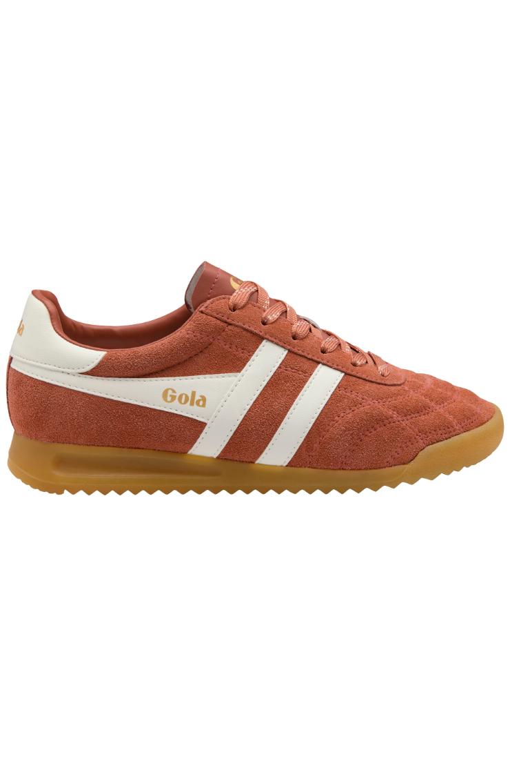 A single Gola brand low-top sneaker in terracotta red suede, featuring two diagonal white stripes on the side, a gold 'Gola' logo, and a brown gum sole, shown against a plain white background.