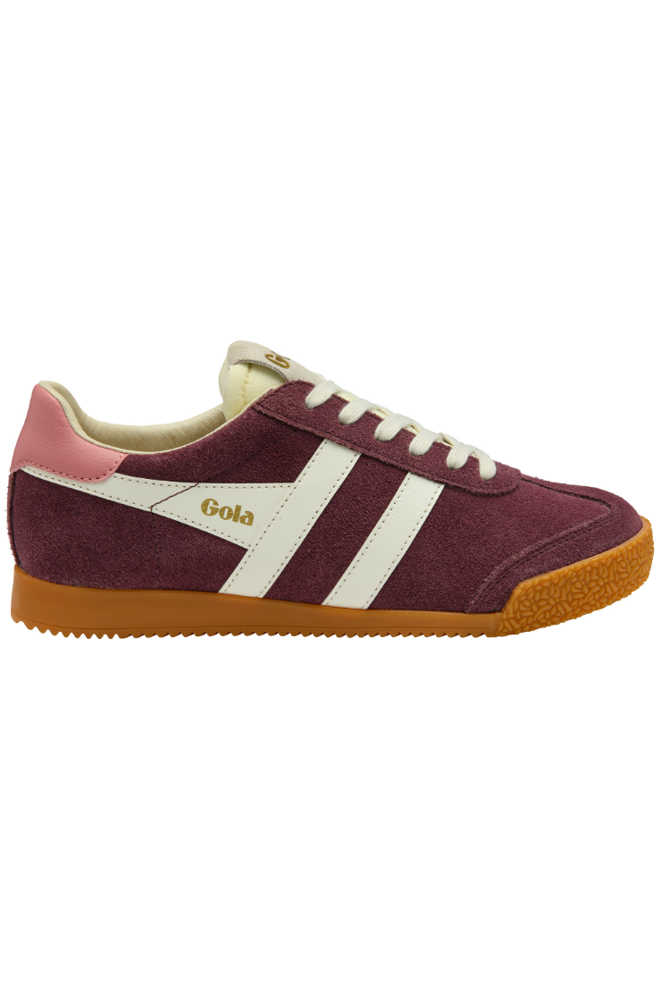 A low-top suede sneaker in burgundy with white side stripes, a light pink heel tab, cream laces and collar lining, and a brown gum sole. The side displays the brand name 'Gola' in gold.