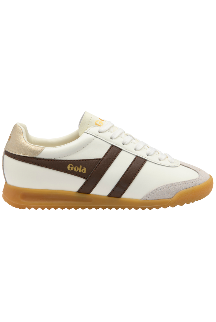 A low-top sneaker in off-white leather with dark brown side stripes, a gold 'Gola' logo, and a gum brown sole, shown from a side profile on a white background.