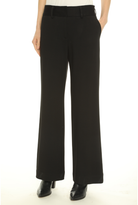 Black wide-leg trousers shown on a model from the waist down, paired with black pointed-toe heels against a plain white background.