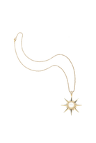 A gold starburst pendant necklace with a central white pearl, displayed on a clean white background.