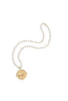 A gold chain necklace with a round medallion pendant featuring an elephant design, displayed on a clean white background.