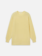 Yellow ribbed sweater on a white background