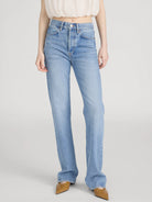 Light blue jeans worn by a person on a white background