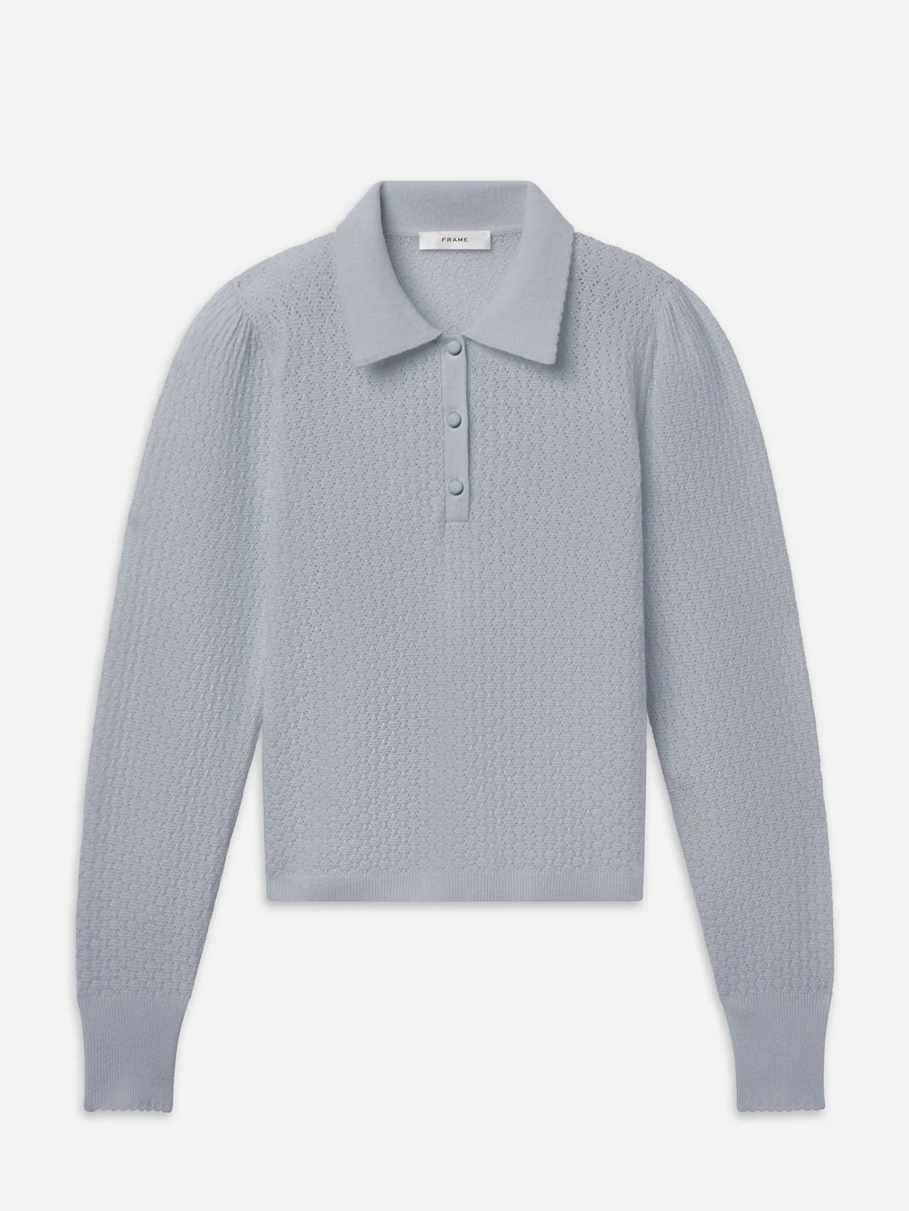 A light gray textured knit polo shirt with a collar and three-button placket, displayed flat against a light gray background.