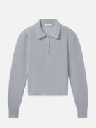 A light gray textured knit polo shirt with a collar and three-button placket, displayed flat against a light gray background.