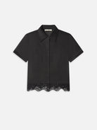 Black shirt with lace trim on a white background