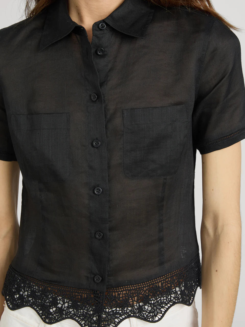 Black short-sleeve shirt with lace trim on a plain background