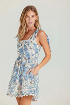 Woman wearing a floral dress on a plain background