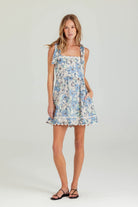 Woman wearing a floral dress on a white background