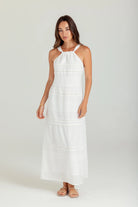 Woman wearing a white dress on a plain background