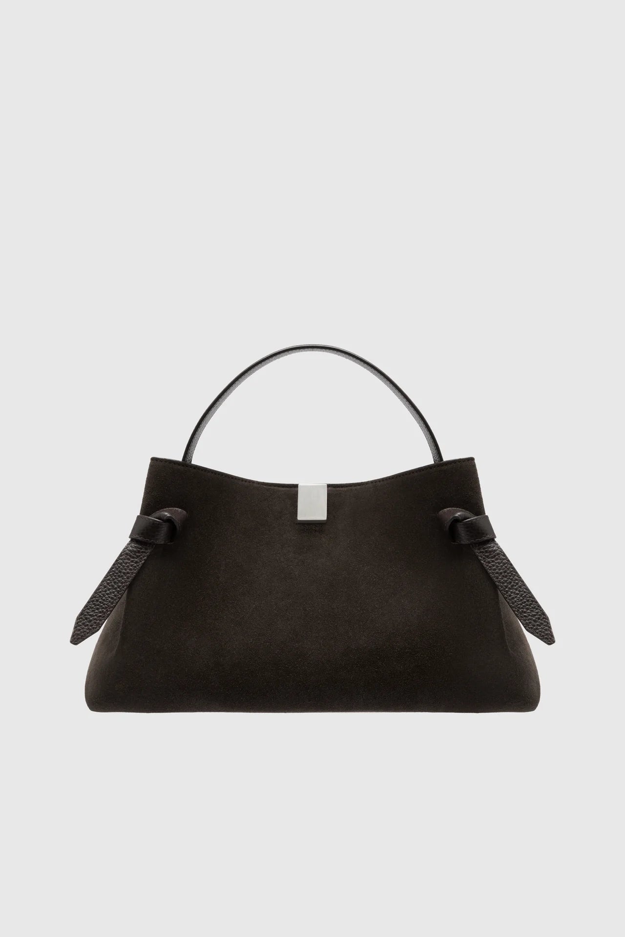Black handbag with a strap on a light gray background