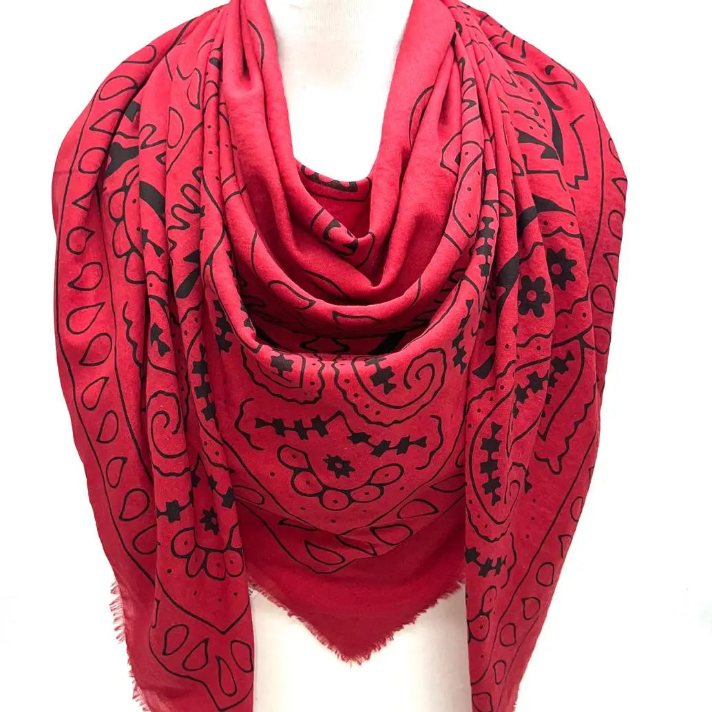 Red scarf with black patterns on a white background